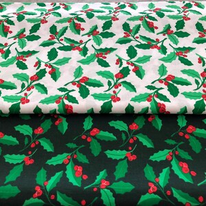 May include: Two fabrics featuring a repeating pattern of green holly leaves and red berries. One fabric is white, the other is dark green. The holly design is a classic Christmas motif, suitable for festive crafts and decorations.