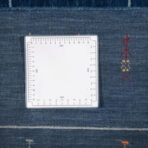 Back corner with square measurement label, shows handwoven weave and clean hem on indian wool gabbeh rug