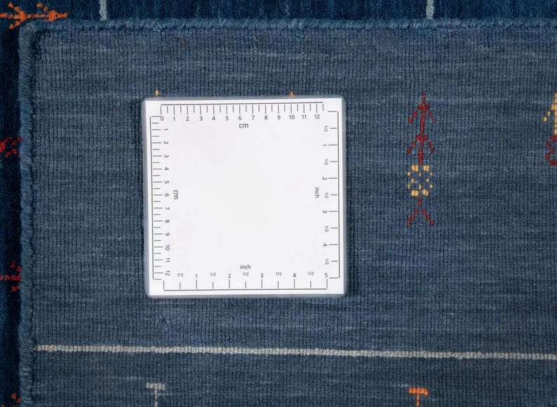 Back corner with square measurement label, shows handwoven weave and clean hem on indian wool gabbeh rug