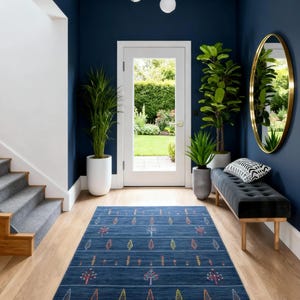 Staged foyer with dark blue wool gabbeh rug 8x10, minimalist boho navy blue area rug grounding hardwood floor