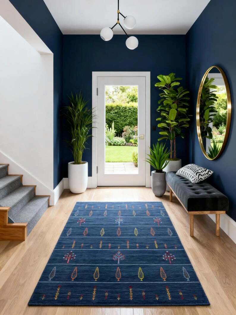 Staged foyer with dark blue wool gabbeh rug 8x10, minimalist boho navy blue area rug grounding hardwood floor
