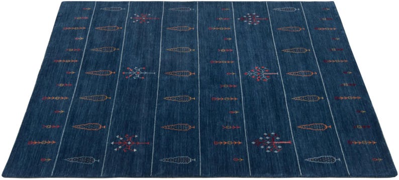 Evenly lit flat lay of minimalist tribal area rug, deep navy field with rust and mustard accents