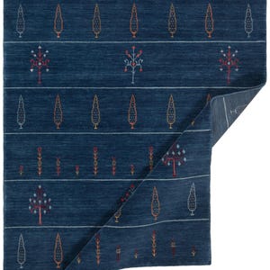 Corner folded to show thin, structured drape and back, 8x10 handmade wool rug construction visible
