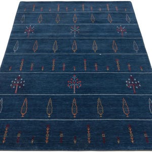 Low-angle shot emphasizing large living room wool rug scale, navy blue wool area rug 8x10