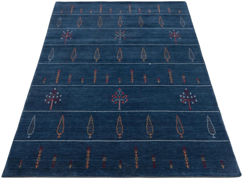 Low-angle shot emphasizing large living room wool rug scale, navy blue wool area rug 8x10