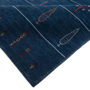 Folded edge exposing underside weave and neat finished edge, ideal for custom size wool area rug presentation