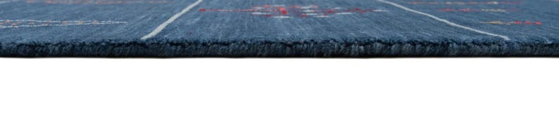 Side profile shows slim 8x10 handmade wool rug thickness, flatwoven look and straight clean edge