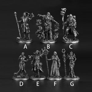 Może przedstawiać: Zestaw siedmiu srebrzystych miniaturowych figurek przedstawiających czarodziejów i czarownice. Każda figurka jest w pozie z laską lub różdżką i stoi na okrągłej podstawie.