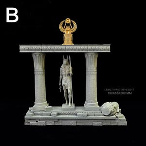 May include: A detailed gray sculpture of an Egyptian temple with columns, featuring a statue of Anubis and a golden winged scarab. The base includes a kneeling figure. Dimensions: 190x55x200 mm.