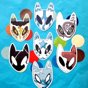 May include: Eight colorful cat mask stickers with different designs. The masks are white with black outlines and various patterns, including stars, clouds, lightning bolts, and swirls.