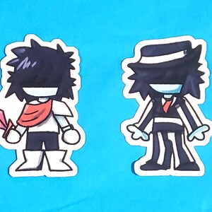 May include: Two cartoon character stickers on a blue background. One character wears a red scarf and holds a pink sword. The other character is dressed in a black and white pinstripe suit and a hat with a red tie.