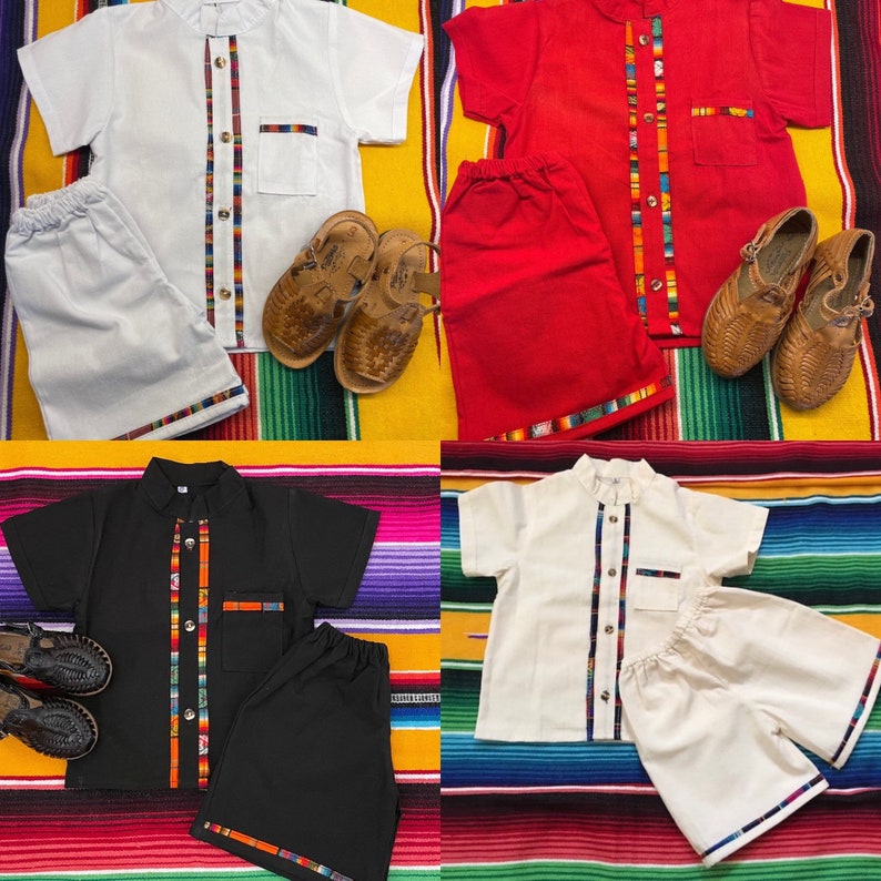 May include: Four sets of children's clothing, each with a short-sleeved shirt and shorts. The shirts have a mandarin collar and a colorful stripe down the front. The shorts have a colorful stripe around the bottom. The clothing is in four different colors: white, red, black, and cream.
