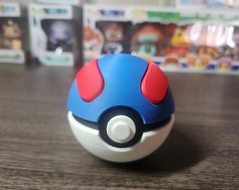 May include: A blue and red Poke Ball with a white center and a black ring around the center. The Poke Ball is a popular toy for fans of the Pokemon franchise.