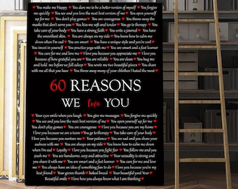May include: A black and red poster with the text "60 Reasons We Love You" and a list of reasons written in red hearts. The poster is framed and hanging on a wall.