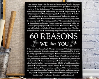 May include: A black and white poster with the text "60 Reasons We Love You" and a list of reasons written in white text on a black background. The poster features two cherubs at the top and bottom.