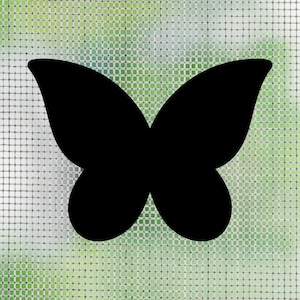 May include: A solid black silhouette of a butterfly with symmetrical wings, featuring rounded upper and lower wing sections. The butterfly shape is presented as a flat, opaque graphic element against a light green and white grid pattern background.