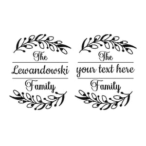 May include: Black and white graphic design featuring two decorative family name signs. Each sign includes the words "The" and "Family", with space for a last name or custom text. Floral leaf accents.