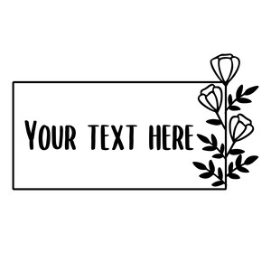 May include: Black and white floral design with the text "YOUR TEXT HERE" inside a rectangular frame. The design includes stylized flowers and leaves, suitable for various craft projects.