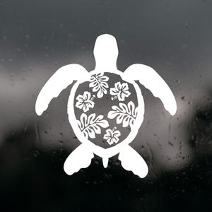 May include: White turtle silhouette with a floral design on its shell. The turtle's shell is filled with white hibiscus flowers and leaves. The image is a graphic design, likely a decal or sticker.