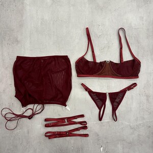 a woman's underwear and accessories laid out on a wall