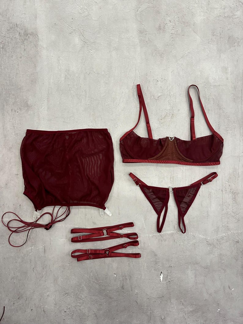 a woman's underwear and accessories laid out on a wall