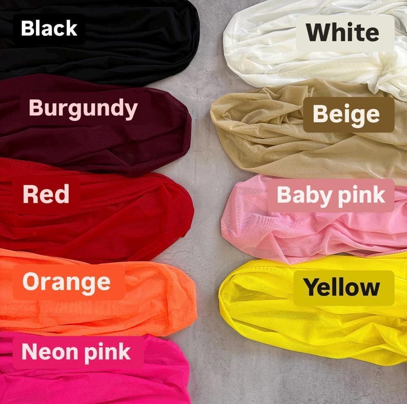a bunch of different colors of clothing on a floor