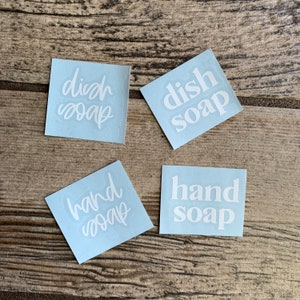 May include: Four white labels with blue backgrounds, each with a different text: "dish soap", "dish soap", "hand soap", and "hand soap".