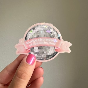 May include: Pink and white sticker with a silver disco ball and the text "make the whole place shimmer".