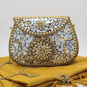 Gold evening clutch. Made of mother of pearl, stones and antique details.