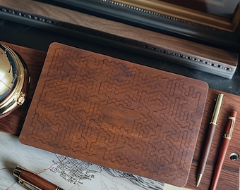 May include: A wooden puzzle with a unique, intricate design. The puzzle is a warm brown color and sits on a wooden desk with two pens. A gold-colored globe and a map are also visible.