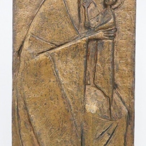 May include: A bronze relief sculpture depicting the Virgin Mary holding the baby Jesus. The sculpture is in a stylised, modern style. The sculpture is signed "FM" in the lower left corner.