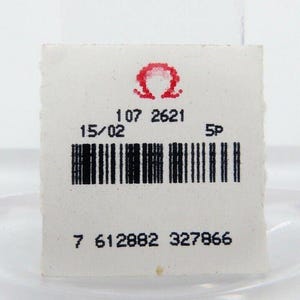 May include: A white label with a red Omega symbol, the numbers 107 2621, 15/02, 5P, and a barcode. The number 7 612882 327866 is printed below the barcode.
