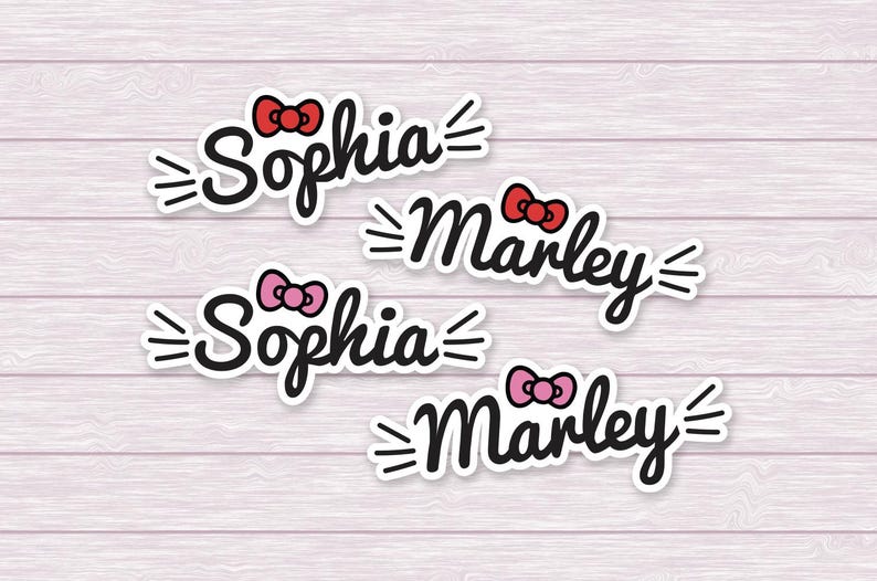 May include: Four custom name stickers featuring the names Sophia and Marley in a black cursive font. Each name is accented with a small bow in either red or pink and three black whiskers on each side, all set against a white border outline.