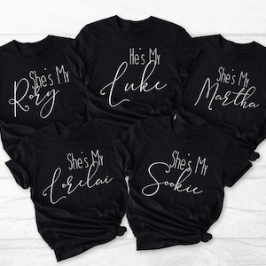 May include: Five black t-shirts with white text. The shirts say "She's My Rory", "He's My Luke", "She's My Martha", "She's My Lorelai", and "She's My Sookie".