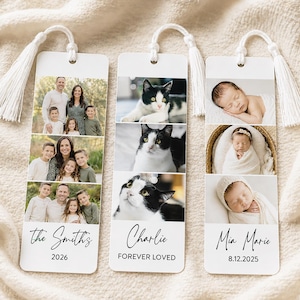 May include: Three personalized bookmarks with white tassels. One features family photos, the second has cat photos, and the third displays baby photos. Each bookmark has a name and date or message at the bottom.