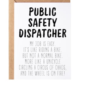 May include: A white card with black text that reads "Public Safety Dispatcher" and a humorous description of the job. The card is on a brown background.