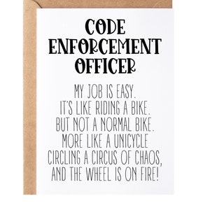 May include: A white card with black text that reads "CODE ENFORCEMENT OFFICER MY JOB IS EASY. IT'S LIKE RIDING A BIKE. BUT NOT A NORMAL BIKE. MORE LIKE A UNICYCLE CIRCLING A CIRCUS OF CHAOS, AND THE WHEEL IS ON FIRE!"