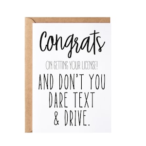 May include: A white card with black text that reads "Congrats on getting your license! And don't you dare text & drive."
