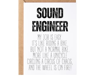 May include: A white card with black text that reads "SOUND ENGINEER MY JOB IS EASY. IT'S LIKE RIDING A BIKE. BUT NOT A NORMAL BIKE. MORE LIKE A UNICYCLE CIRCLING A CIRCUS OF CHAOS, AND THE WHEEL IS ON FIRE!"