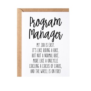 May include: A white card with black text that reads "Program Manager" and a humorous description of the job: "My job is easy. It's like riding a bike. But not a normal bike. More like a unicycle circling a circus of chaos, and the wheel is on fire!"