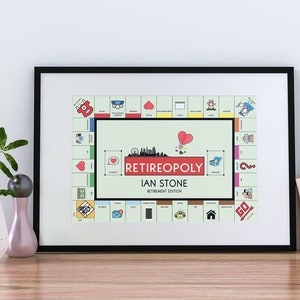 May include: A framed print of a personalized "Retirepoly" board game, featuring the name "Ian Stone" and the text "Retirement Edition". The board game is a parody of Monopoly, with a green background and colorful squares.