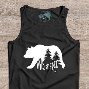 May include: Black tank top with a white silhouette of a bear walking through a forest with the text "Wild & Free" underneath.
