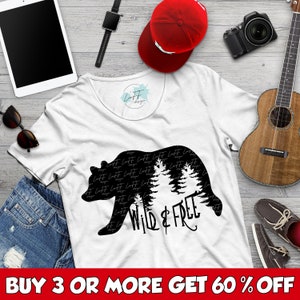 May include: White t-shirt with a black silhouette of a bear with trees inside the bear. The text "Wild & Free" is written below the bear.