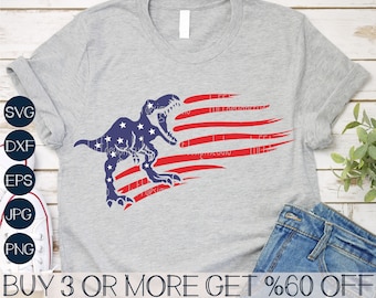 May include: A gray t-shirt with a red, white, and blue American flag design featuring a blue dinosaur silhouette. The text "BUY 3 OR MORE GET %60 OFF" is at the bottom of the shirt.