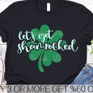 May include: A black t-shirt with a green shamrock design and the text "let's get shamrocked".