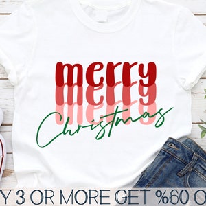May include: White t-shirt with the text "merry christmas" in red, pink, and green layered lettering.