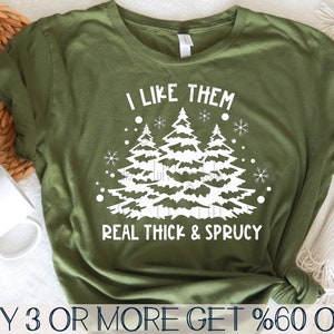 May include: Green t-shirt with a white design of three Christmas trees and the text "I like them real thick & sprucy".