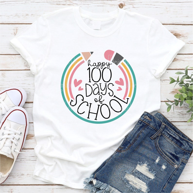 May include: White t-shirt with a colorful graphic that says "happy 100 days of school" with a rainbow and hearts.