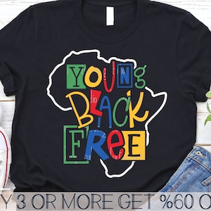 May include: A black t-shirt with a white outline of the continent of Africa. The words "Young Black Free" are written in colorful letters inside the outline of Africa. The words "Buy 3 or More Get %60 Off" are written at the bottom of the image.