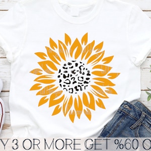 May include: A white t-shirt with a yellow sunflower with a black leopard print center. The text "BUY 3 OR MORE GET %60 OFF" is at the bottom of the image.